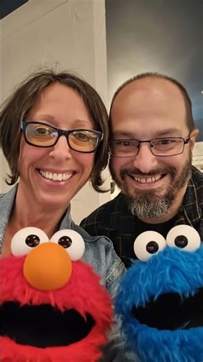 Elmo and Cookie Monster stick their heads out to my aunt and uncle