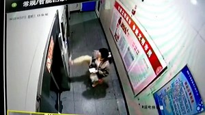 Woman uses her foot to press elevator buttons in China