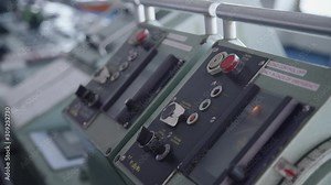 Closeup view of control panel of cruising ship traveling by sea. Modern technical system of navigation and dashboard with buttons in interior of vessel during maritime. Concept: navigating, technology