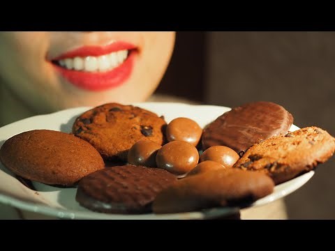 Girl eats Chocolate Cookies. Close up Camera. Chewed food warning. Mouth shot.