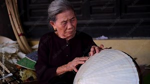 old woman making conical hats - Vietnamese name is Non la. Lang Chuong village, Hanoi city, Vietnam