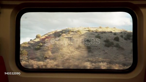 View of New Mexico landscape from train car window, POV