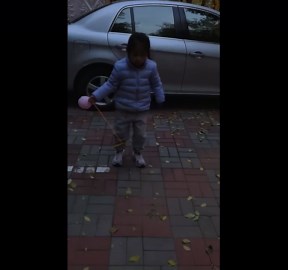 Girl trips while playing with rope and ball in Liaoning, China