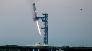 SpaceX mechanical arms catch Starship rocket booster on launch pad