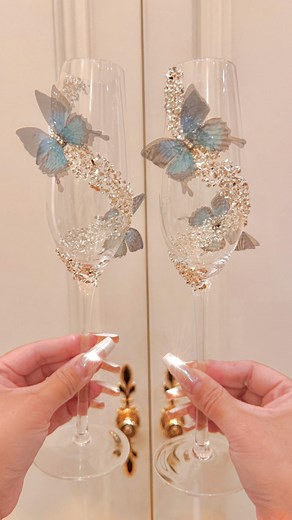 New exclusive design: Butterfly Kisses Crystals Champagne Flute Set is here 🦋. When every toast feels like a kiss from a dream. Delicate. Romantic. Unforgettable. Each glass is handblown to perfection and adorned with fluttering butterflies crafted from airy fabric, nestled among shimmering hand-placed crystals. Designed to enchant, these flutes transform your dinner table into a fairytale setting. As you pour your champagne and raise a glass, soft sparkles dance through the air—like a butterfl