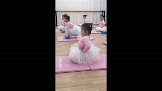 Young student holds posture during ballet training, Guangxi, China
