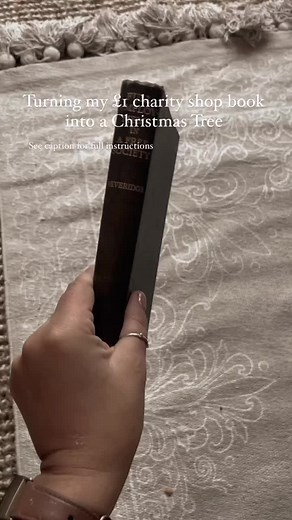 DIY Christmas Crafts⁠ 🎄Book page Christmas Tree⁠ ⁠ This one is so super simple. All you need to do is hunt around your home for a book. You no longer need it head to the charity shop. I can pick up three books for £1 at mine.⁠ ⁠ Here, you want to remove about 100 pages carefully. Start by folding one page towards the centre, then take that page and fold it towards the centre once more.⁠ ⁠ You’ll have a little overhanging; you need to fold that back up so it sits level with the bottom of the res
