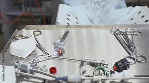 Close up hands and a table of surgical nurse during laparoscopic operation.