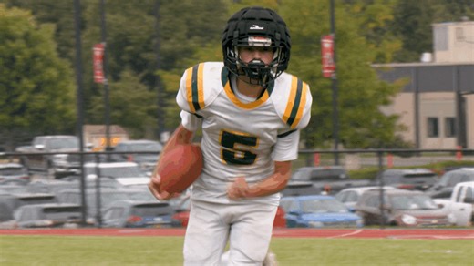 Charles G Finney football runs past Holley