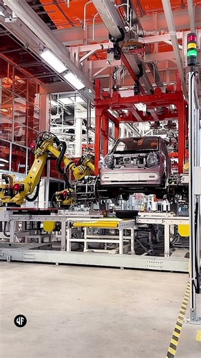 Robotic arm installs tire