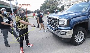 Indianapolis protesters block traffic, draw guns on driver