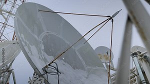 satellite dish. television radio tower. signal from a satellite transmitted by an antenna. reception and transmission of signals between earth stations and artificial earth satellites. technologies