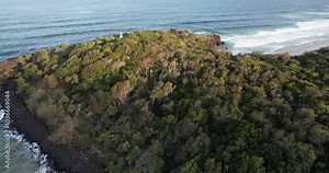 Aerial views of Fingal Head Lighthouse with the causeway rock formations below in Fingal Head, New South Wales, Australia