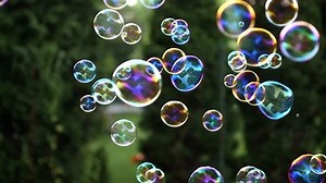 Close up of soap colorful bubbles floating in the air.