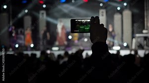Hand Holding Record Video Camera Smartphone Live Concert Performance Taking Photo Music Band Silhouettes Dancing People Applauding Raising Hands Up Crowd Applauds Rhythm Music Musicians Perform Stage Stock Video