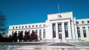 A daytime time-lapse of the Marriner S. Eccles Federal Reserve Board Building in Washington, D.C. on a sunny winter day. The camera pans from left to right.