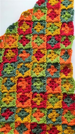 Happy because I sewed my ends in!! 😅 I've finished the granny squares half of my shawl, not onto the moss Stitch side 😊 This lovely pattern is the Fox's Way Shawl from @wittycraftsdesign Yarn is Merino Care @hobbii_yarn #sponsored #noshadesofgrey ❤️💛💚 #shawl #crochet #crochetersoftiktok