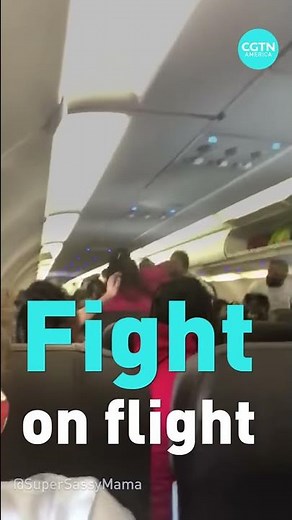 Watch American Airlines passengers fight on a plane over masks.