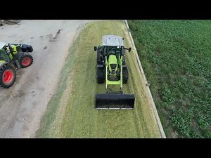 Claas Arion 450 Spreading Silage on the Silo