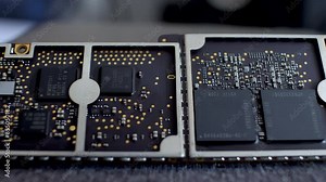 A detailed view of a tablet motherboard with various integrated circuits and connectors, focused on the central area. Dolly Left