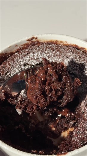 Protein lava cake 🤤🍫 Instructions: 1. Preheat oven or air fryer to 350°F. 2. Blend ⅓ cup cottage cheese until completely smooth and add it to a bowl. 3. In the same bowl, combine 1 egg (or vegan alternative), 2 tbsp. flour, 1 scoop Chocolate Fudge All-in-One Shake, 1 tbsp. melted coconut oil, ¼ cup almond milk, 1 tsp. baking powder, and ½ tsp. vanilla extract. Mix well. 4. Pour batter into a greased ramekin. 5. Bake for 15-20 minutes or air fry for 10-12 minutes, until edges are set and centre