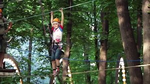 Climbing on trees, outdoor kids game. Kids rope park. Adventure activity in forest.