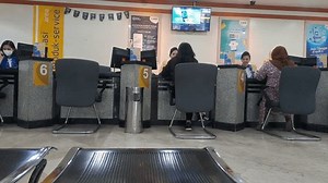 SURABAYA, INDONESIA - SEPTEMBER 10, 2024: The situation of crowds and queues of people in a bank to take care of: making a new ATM, taking care of ATM problems, and other matters. Financial activities