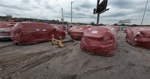 Dozens of Cars Found Wrapped in Red Plastic in an Yard. What Does the Wrap Actually Hide?