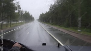 view through the windshield of a tourist bus moving along the highway
