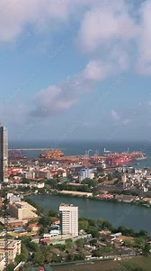 Smooth drone panning across Colombo s major shipping port and harbor area, showcasing logistic terminals and coastal infrastructure - ideal for commercial, trade, and global transport visuals.