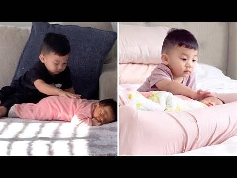 Cute Brother Watches Over Newborn Baby Sister