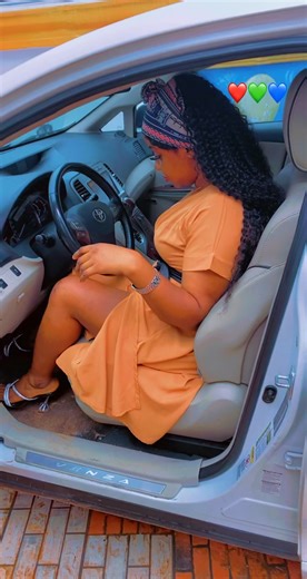 Elegant Woman in Orange Dress Exiting Chic White Car