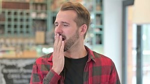Portrait of Sleepy Young Man Yawning