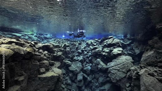Scuba diver exploring the tectonic plates of Silfra fissure in Thingvellir National Park, Iceland