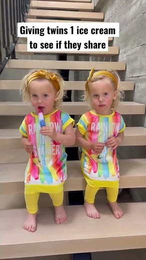 Twin babies sharing 1 popsicle
