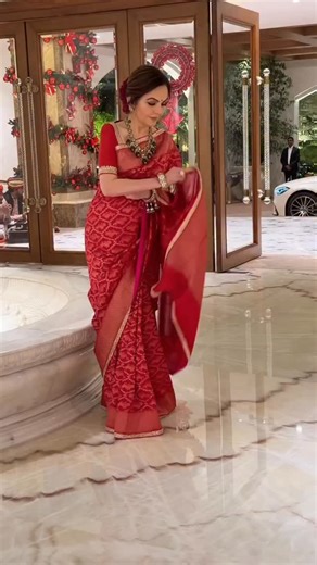 Pallav Paliwal on Instagram: "Draped in a luminous red Banarasi, our founder, Mrs Nita M. Ambani, honours India’s legacy and craftsmanship. Handwoven using the revered Kadhwa technique that is practiced today only by a few master artisans, each motif on the saree is individually formed by hand on the loom, lending the fabric its sculpted richness and depth. Handwoven in Banaras by master artisan Vijay kumar Maurya and his son Vibhas Kumar Maurya, this saree features intricate lion motifs symboli