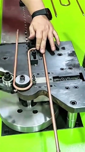 Hand guides copper rod machine bends precise form
