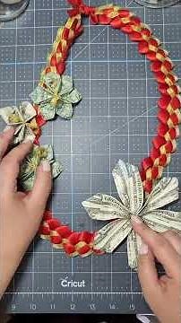Attach money flowers to a ribbon lei