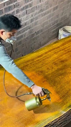 Polishing wood to a glossy finish, revealing its natural beauty and creating an elegant table.