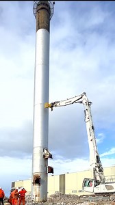 Skillings new Liebherr R950 high reach machine pushing over a tall chimney on a demolition project for John F Hunt Regeneration. Double click to enlarge the frame for the whole picture. | RPA Media