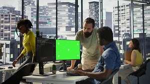 System administrator does software debugging on isolated screen PC, asking for help from coworker. Zoom in on admin fixing coding mistakes on chroma key computer, being assisted by colleague, camera B