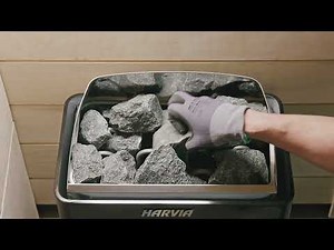 Harvia - Stacking sauna stones into a wall-mounted electric heater