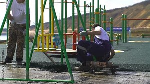 Roofer cover the concrete base, polymer modified bitumen waterproofing primer