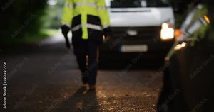 4K Portrait smiling female recovery driver at the scene of car breakdown. Slow motion.