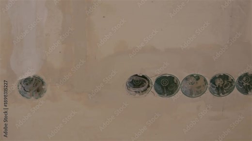 Electrical outlet boxes installation process showing sequential wiring steps on a wall surface. Electrical outlet boxes. Installation and wiring