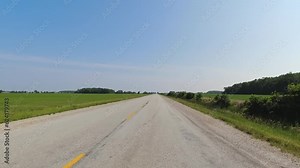 Cinematic POV shot of asphalt country side road Canada. Point of view, front car view. Road ahead driving view during travel driving on the highway. Vehicle car speeding view above the road surface.