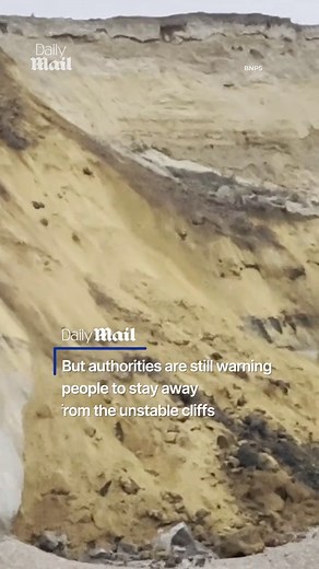 Moment huge cliff collapses 130ft onto English beach