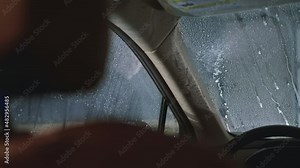 Checking after applying a layer of protective coating anti-rain on windows and windshield. View from inside the automobile. Carwash or Car Detailing process