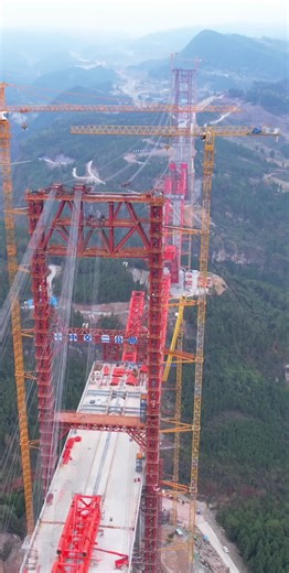 Massive Red Bridge Construction in Mountainous Setting