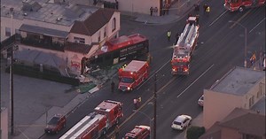Investigation continues after car crashes into bus causing it to veer into building in Long Beach